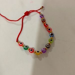 2 new homemade bracelets one with smiley faces and other with eye ball charms